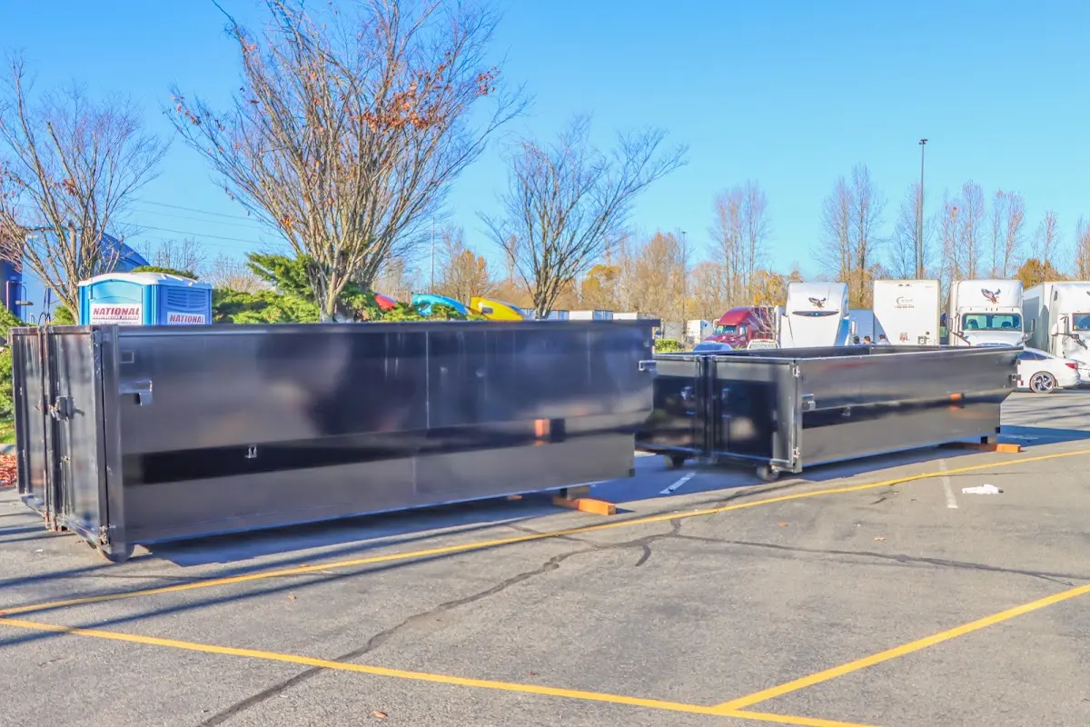 Professional dumpster rental service with roll-off container on residential driveway in The Acreage